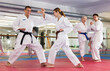 © JackF - Man and woman in kimono sparring together in gym during karate training