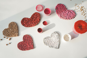 Wall Mural - Children's creativity from heart-shaped cereals top view, fine motor skills development concept