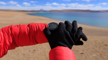 Wall Mural - Hiker on high altitude mountain top checking the altimeter on the sports watch