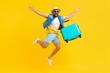 © RicardoLuiz - Happy male traveler jumping with suitcase on vivid background. Generative AI.