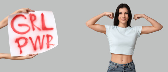 Wall Mural - Young woman showing muscles and hands holding placard with slogan GRL PWR on grey background. Feminism concept