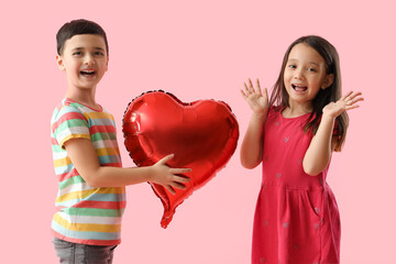 Canvas Print - Cute little boy giving heart-shaped balloon to girl on pink background. Valentine's Day celebration