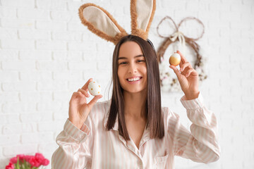 Poster - Young woman with bunny ears and Easter eggs in bedroom