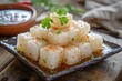 Brazilian northeast s famous tapioca cubes served with spicy syrup on a wooden table