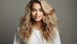 © Stockgiu - Beautiful woman with long blond curly hair smiling at camera generated by AI