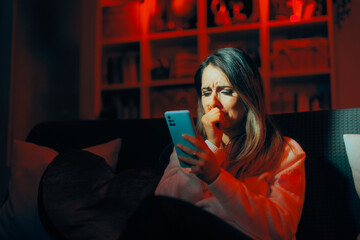 Woman Crying Reading a Text Message from Ex-Boyfriend. Upset woman feeling desperate after text separation message 
