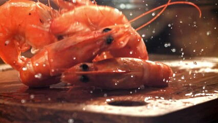 Poster - The shrimp falls on a wooden cutting board. Filmed on a high-speed camera at 1000 fps. High quality FullHD footage