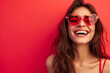 canvas print picture - Studio portrait of a cool young woman posing wearing heart shaped love sunglasses