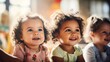 © tashechka - Three joyful toddlers with curly hair playing together, brightly lit with natural sunlight, showcasing childhood innocence.