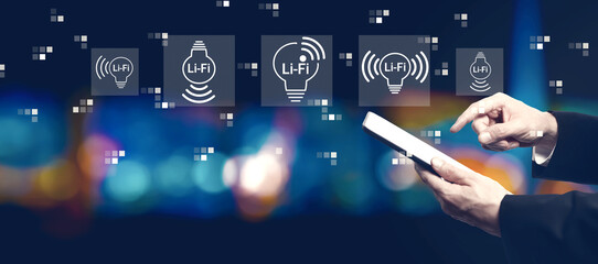 Poster - LiFi theme with businessman using a tablet computer at night