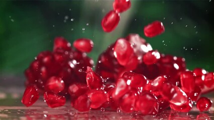 Poster - Pomegranate seeds fall on the table with splashes. Filmed on a high-speed camera at 1000 fps. High quality FullHD footage