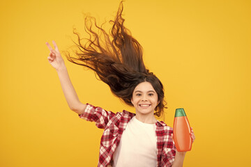 Canvas Print - Child teen girl with shampoos conditioners and shower gel. Long hair care of teenager. Presenting cosmetic product, shampoo bottle. Amazed teenager. Excited teen girl.