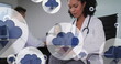 Image of cloud icons over biracial female doctor