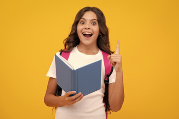 Sticker - Amazed teen girl. School teenage girl with school bag backpack hold book on yellow isolated studio background. Children school and education concept. Excited expression, cheerful and glad.