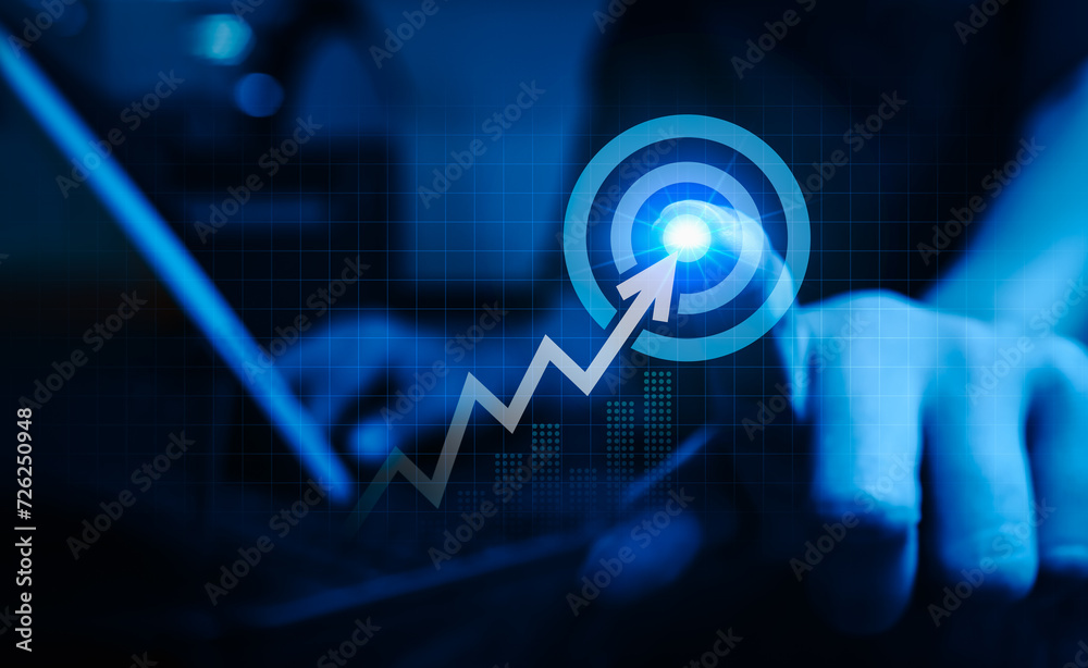 Businessman pressing on big target dart icon with rising arrow graph ...