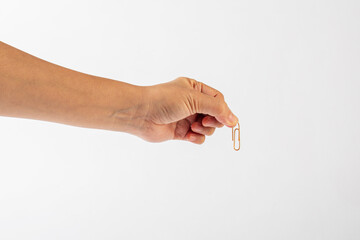 Wall Mural - Colorful paper clip in hand isolated on white background