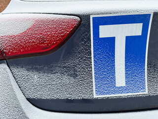 Tail light of a car covered with snow in winter time