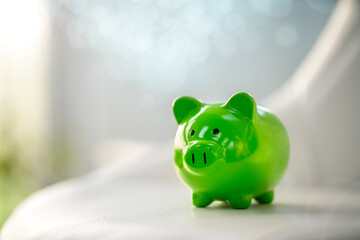 Wall Mural - Green piggy bank saving, accounting, banking and business account or sustainable and environmentally friendly finance