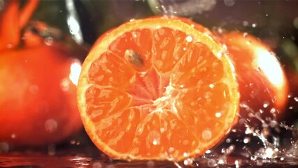 Poster - Raindrops drip on a fresh tangerine. Filmed on a high-speed camera at 1000 fps. High quality FullHD footage