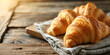 French croissant on a napkin on wooden table banner with copy space