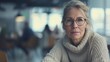 © R Studio - Mature woman with glasses in a contemplative mood, portraying introspection or awaiting service