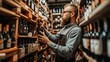 © Andrei - Experienced wine merchant showcasing a premium bottle of red wine in his well stocked, vibrant shop.