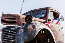 Abandoned Old Truck With American Flag On The Roof.