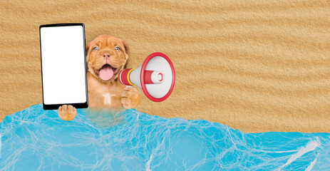 Poster - Happy Mastiff mastiff puppy lying at sunny beach and showing big smartphone with white blank screen in it paw and screaming into a megaphone. Empty space for text
