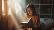 A person reading a book in a sunbeam with a peaceful and contented smile.