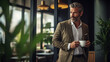 A focused photo captures a cropped view of a mature entrepreneur in a jacket, taking a coffee break at the office.