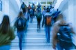 Blurred shot of high school students walking up the strs between classes in a busy school building