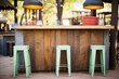iron and wood bar stools at a rustic outdoor counter