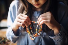 Girl Adjusting A Beaded Necklace, Accessory Detail In The Forefront
