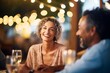 smiling couple dining, soft focus fairy lights, balmy evening air