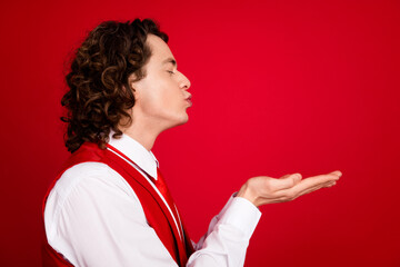 Poster - Side profile photo of closed eyes guy with necktie and vest hold two arms sending air kisses pouted lips isolated on red color background