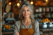 © bird_saranyoo - A smiling middle-aged woman stood at the entrance to her shop in the cafe.