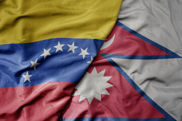 big waving national colorful flag of nepal and national flag of venezuela . macro