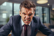 © Emre Akkoyun - Angry middle aged boss in the office. Portrait of furious businessman.