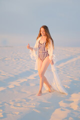 Girl on the evening beach in a romantic way