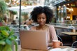 © Tymofii - Beautiful black woman is sitting at the cafe with laptop, freelancer, remote work