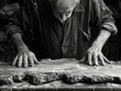 old man doing wood carving
