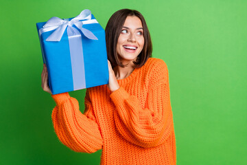 Wall Mural - Photo of positive nice lady hands hold giftbox toothy smile look empty space isolated on green color background