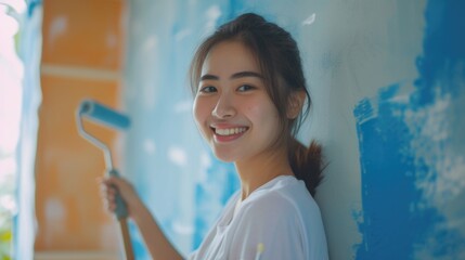 Aufkleber - A woman holding a paint roller and smiling. Perfect for home improvement projects and DIY enthusiasts