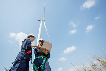 Team engineer wind turbine worker safety uniform survey discuss operational planning windmill field clean energy. Alternative technology protect environment reduce global warming problems.