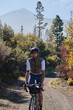 © KatyaPulka - Fit male cyclist riding a gravel bike a gravel road with view on Teide volcano. Cyclist training on beautiful forest trail. Sport motivation. Adventure travel on bike. Tenerife, Canary Island.