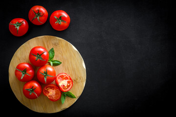 Wall Mural - Tomatoes and basil on wooden board, top view. Cooking background