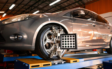 Car wheel alignment is in progress. auto camber toe check fixing. sensor during suspension adjustment and automobile wheel alignment work at the repair service station