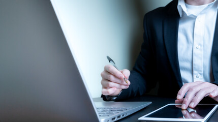 Businessman using digital tablet and laptop, global business and e-commerce concept.