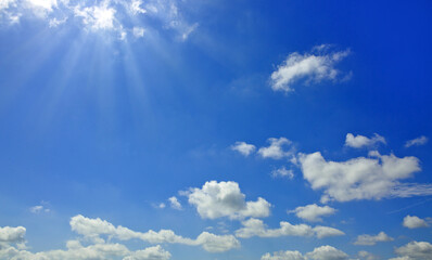 Wall Mural - Blue sky background with sunlight and white clouds. Nature summer background.