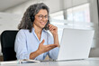 © insta_photos - Happy mature business woman call centre representative customer support agent talking to client, smiling middle aged senior female operator wearing headset working using laptop computer in office.